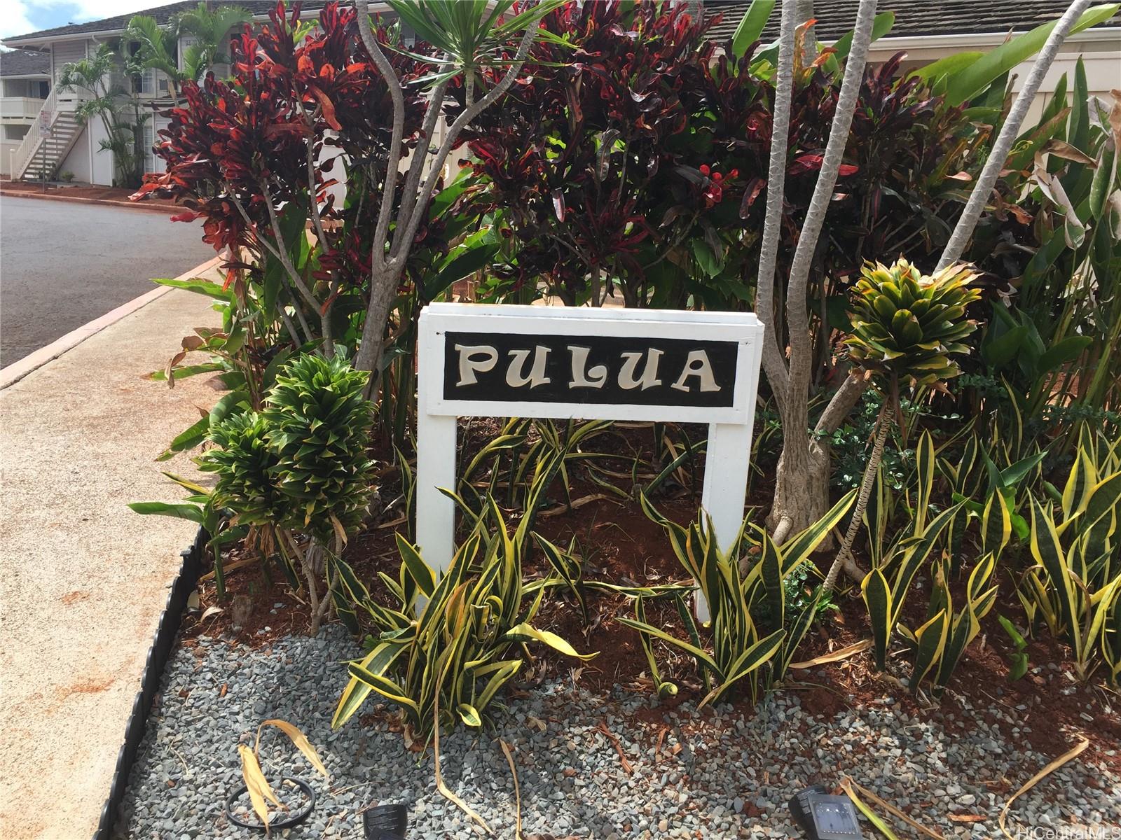 a sign that is on a brick wall