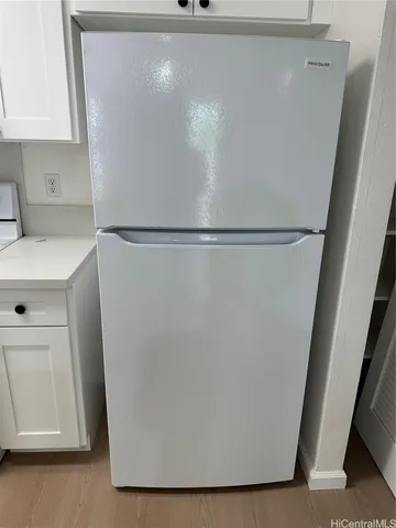 a utility room with cabinets washer and dryer