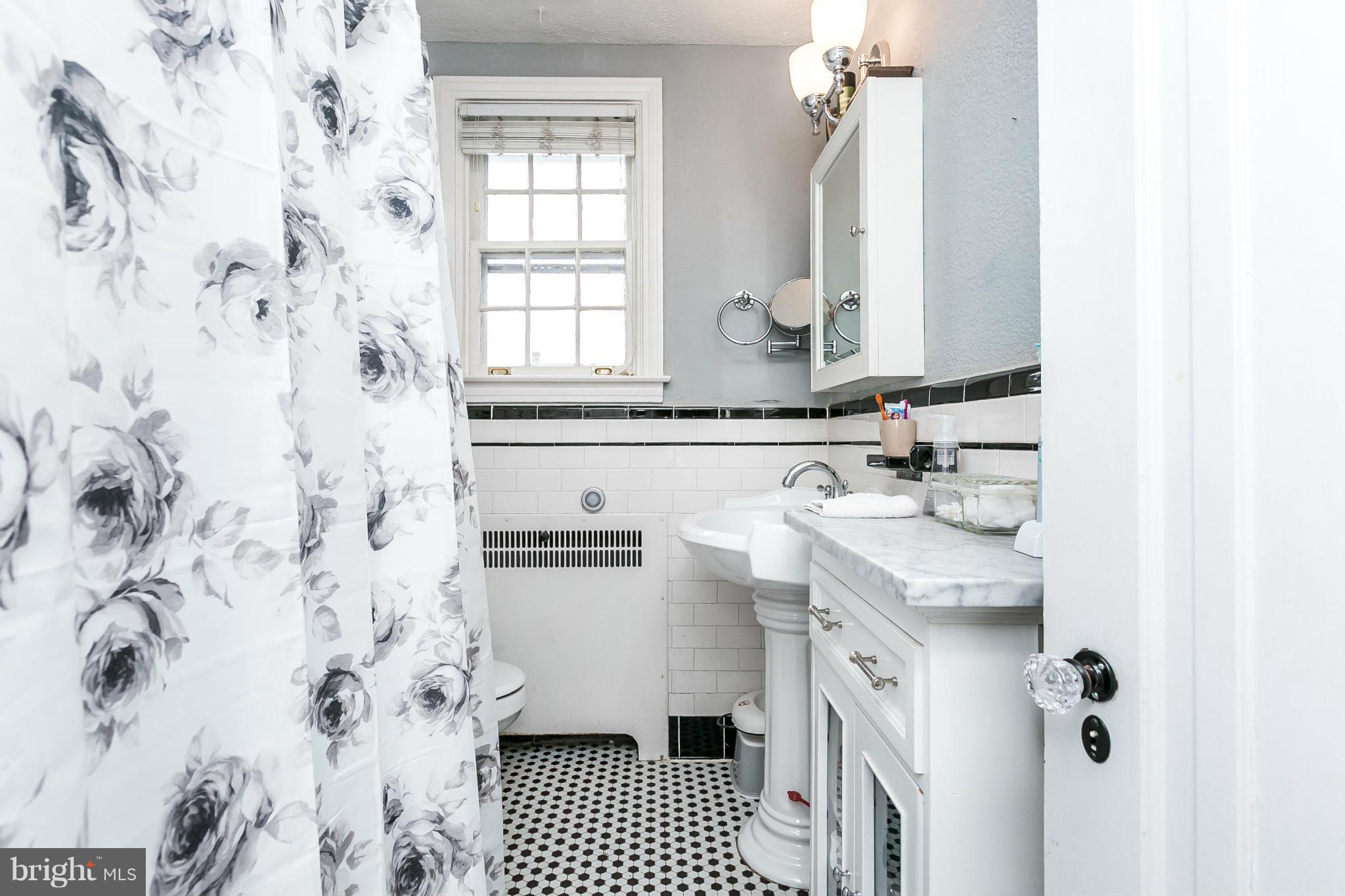 402 Murdock Road Baltimore, MD 21212 - Photo 14 of 24 a bathroom with a sink and a mirror