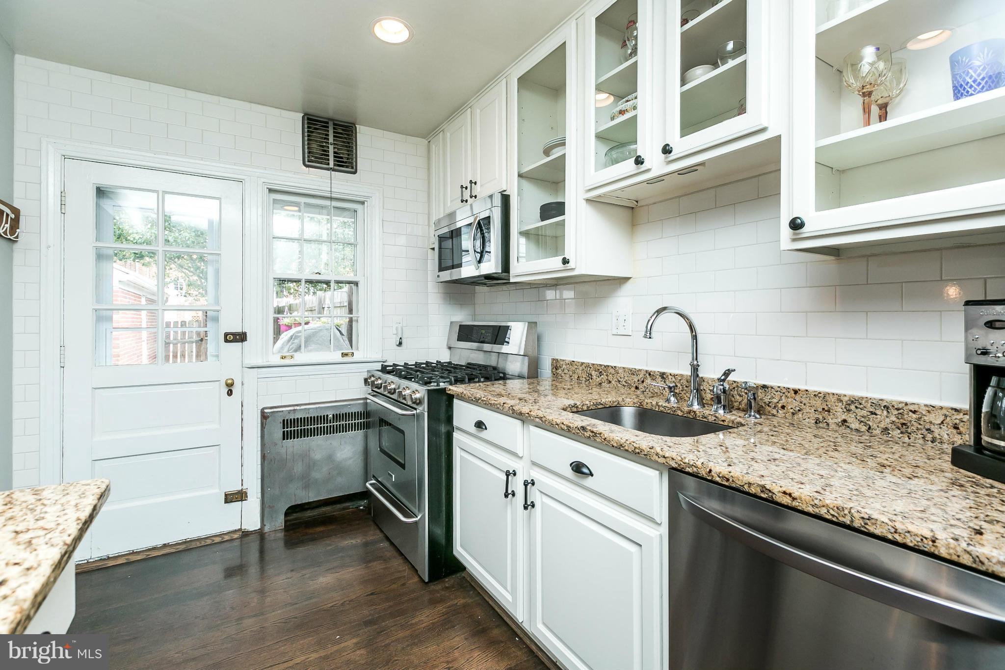402 Murdock Road Baltimore, MD 21212 - Photo 8 of 24 a kitchen with stainless steel appliances granite countertop a sink stove and cabinets
