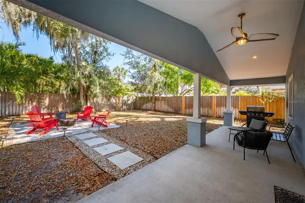 a living room with patio furniture and a potted plant