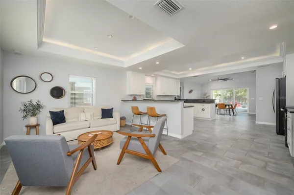 a living room with furniture and kitchen view