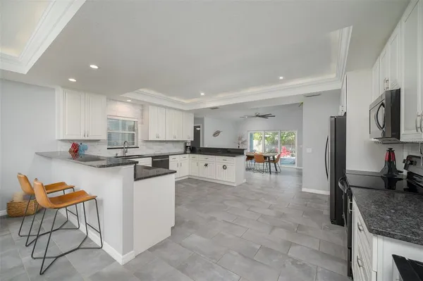 a kitchen with stainless steel appliances granite countertop a sink and cabinets