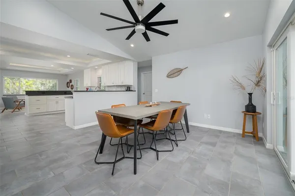 a view of a dining room with furniture and a kitchen