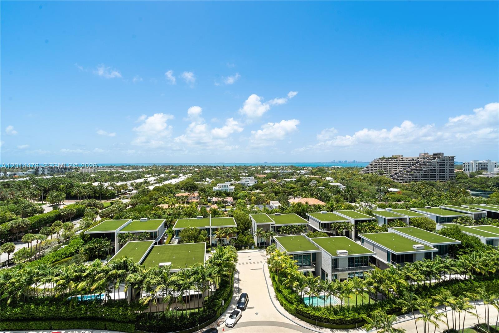 360 Ocean Drive, Unit 1106S Key Biscayne, FL 33149 - Photo 18 of 67 View – Panoramic views stretch over tropical landscaping, nearby residences, and sparkling water in the distance. The elevated perspective captures the property’s coastal setting and surrounding greenery.