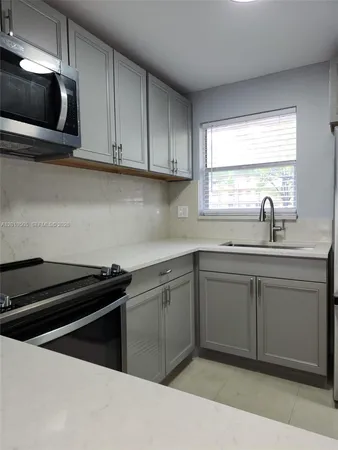 a kitchen with a sink and cabinets
