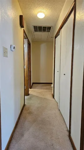 a view of hallway with wooden floor