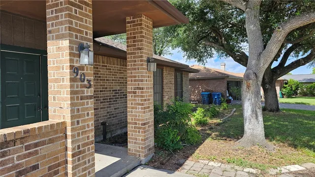 a brick building with a tree in front of it