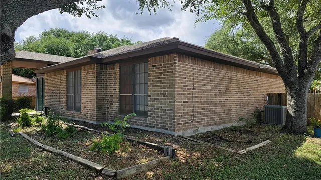 a side view of a house with a yard