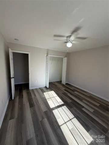 a view of bedroom with wooden floor