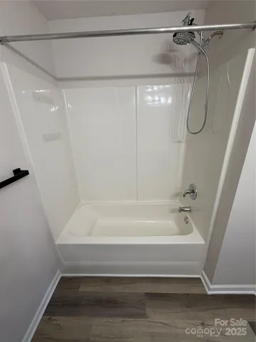 a bathroom with a shower and a bath tub