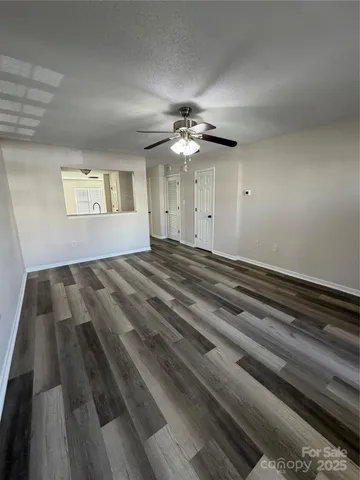 a view of a room with a ceiling fan and a ceiling fan