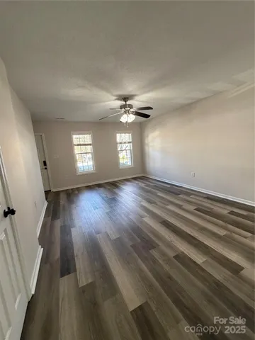 a view of an empty room and a window