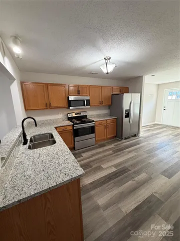a kitchen with refrigerator and stove