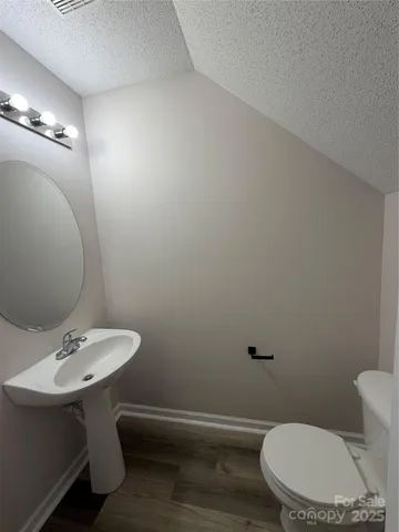 a bathroom with a sink a toilet and mirror