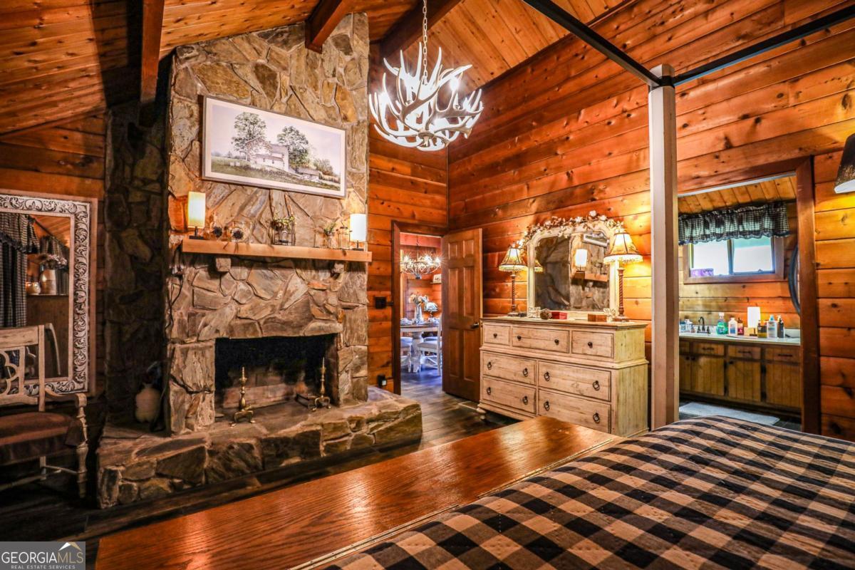 75 Deerfield Road Covington, GA 30014 - Photo 15 of 44 a hallway with a stove and a fireplace with wooden floor