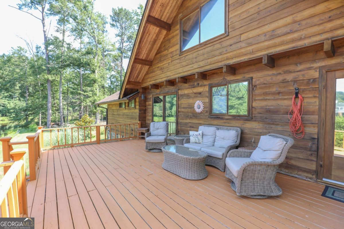 75 Deerfield Road Covington, GA 30014 - Photo 34 of 44 a view of a patio with table and chairs and wooden floor