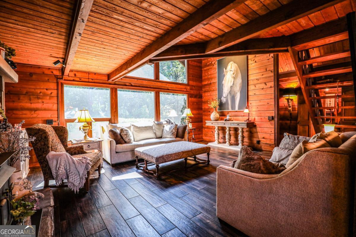 75 Deerfield Road Covington, GA 30014 - Photo 5 of 44 a living room with furniture a large window and wooden floor