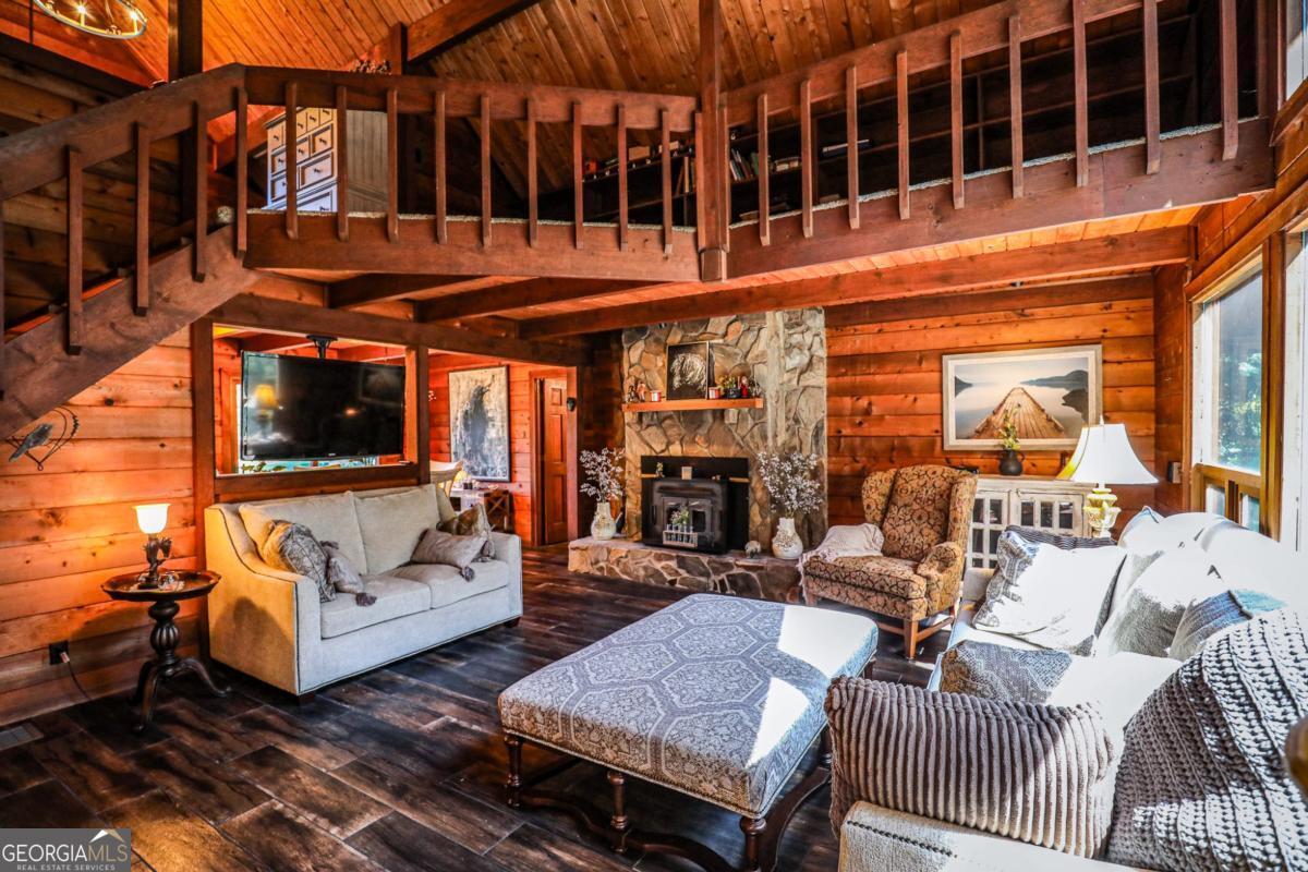75 Deerfield Road Covington, GA 30014 - Photo 7 of 44 a view of a patio with couches and a dining table and chairs with wooden floor