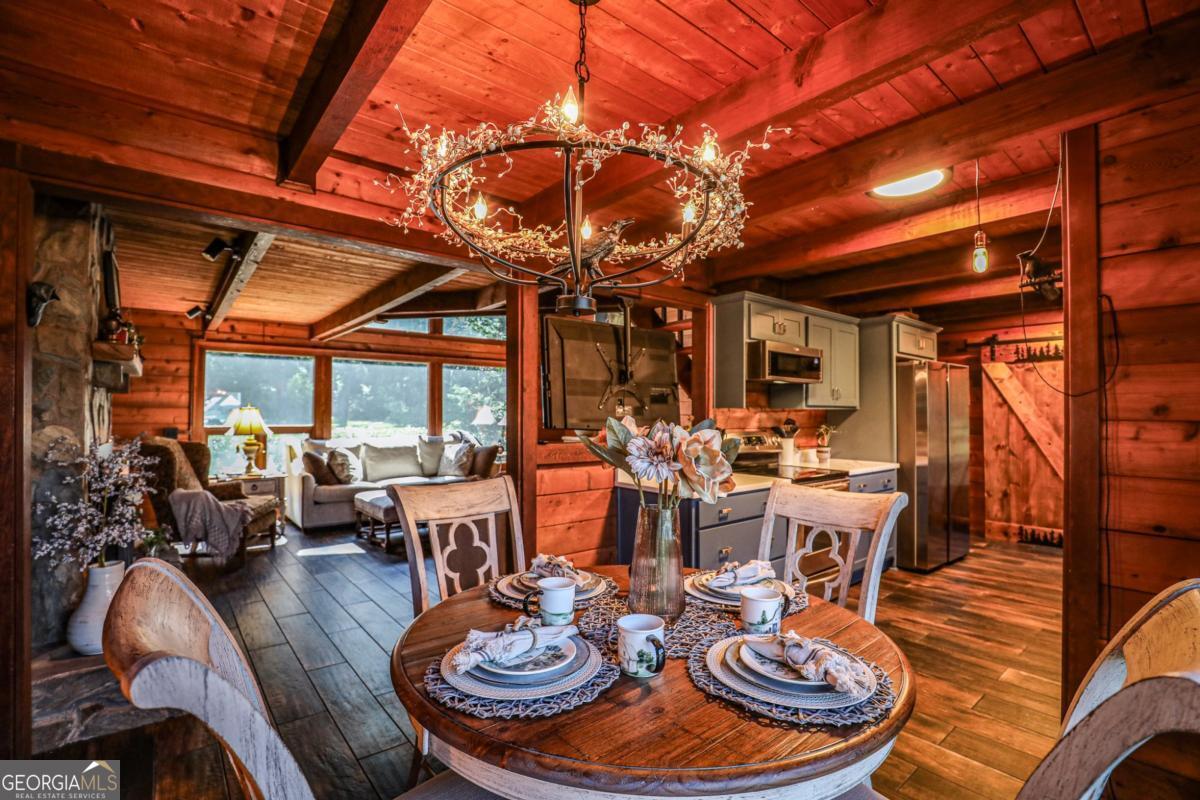 75 Deerfield Road Covington, GA 30014 - Photo 8 of 44 a dining room with furniture wooden floor and a chandelier