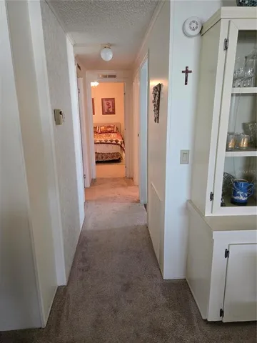 a room with wooden floor and white wooden cabinets