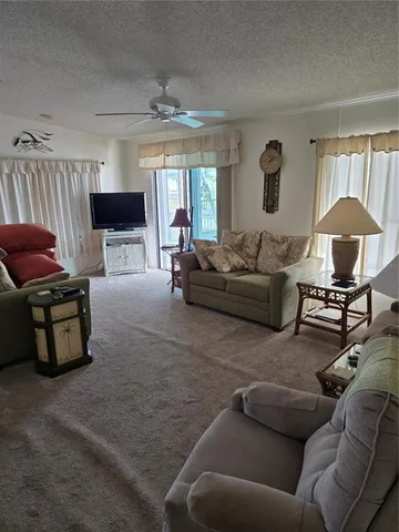 a kitchen with a refrigerator and white cabinets