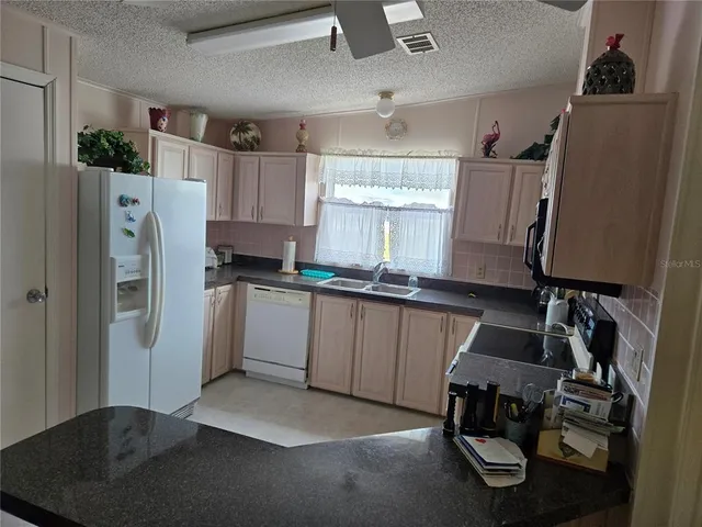a white refrigerator freezer sitting in a kitchen