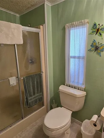 a white toilet sitting next to a shower curtain