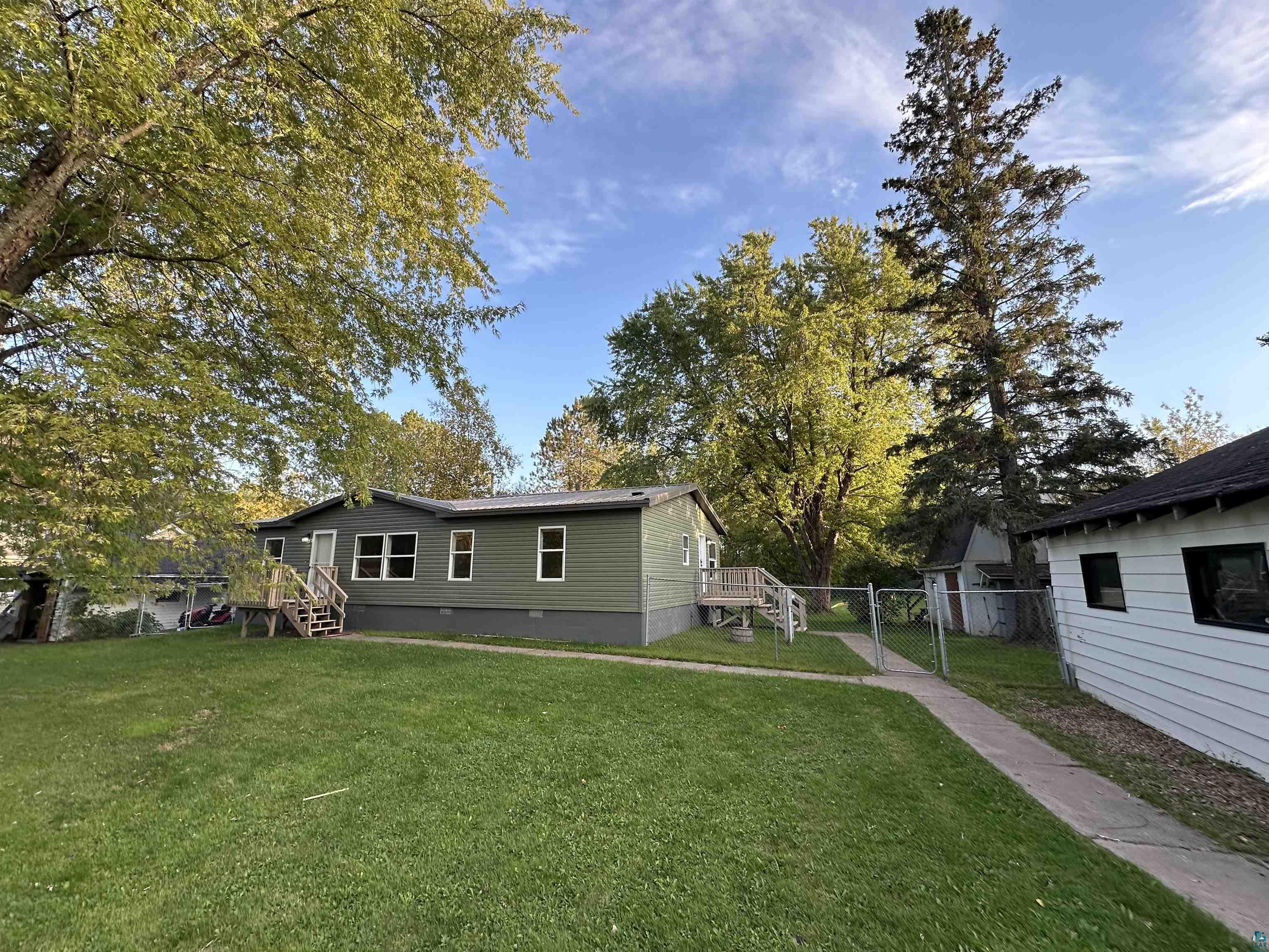 View of home's exterior featuring a gated lawn