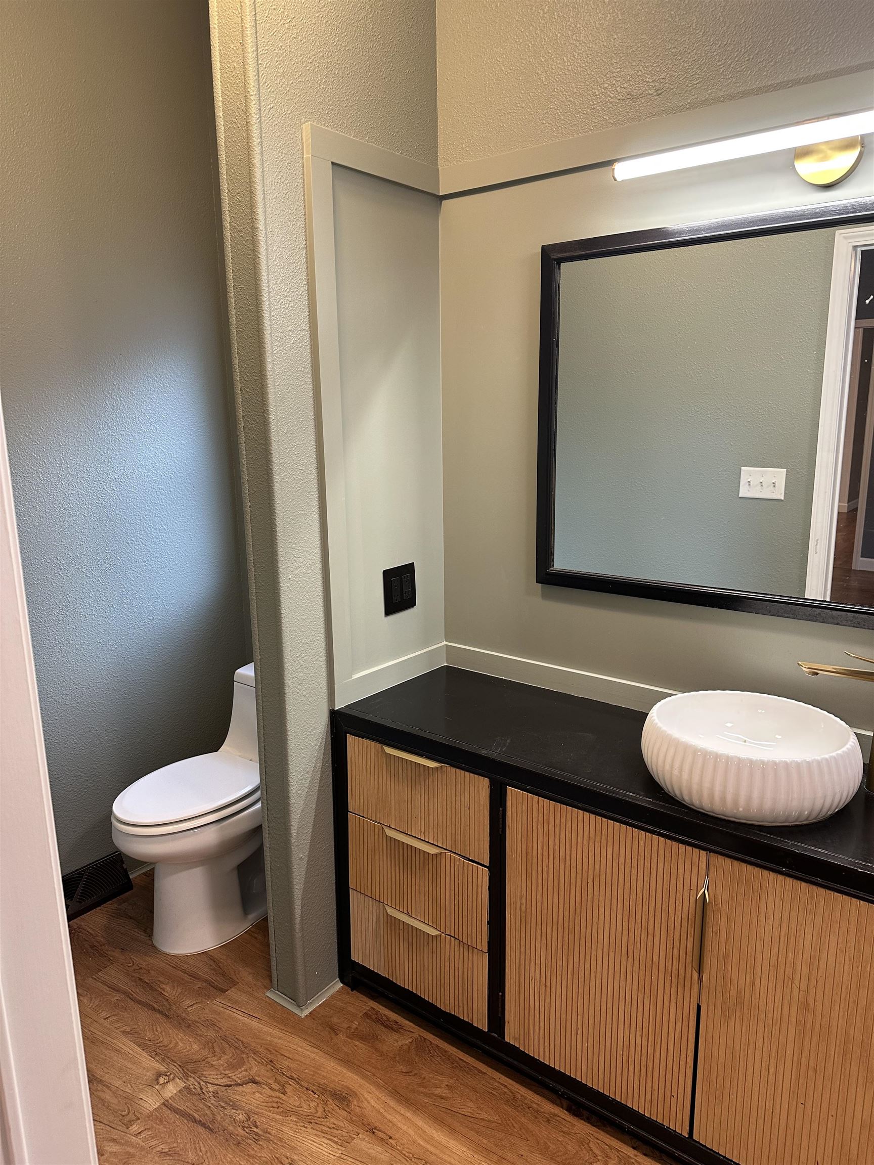 3748 Mulvahill Road Rice Lake, MN 55803 - Photo 13 of 26 Master bathroom with a textured wall, dark wood-type flooring, and vanity