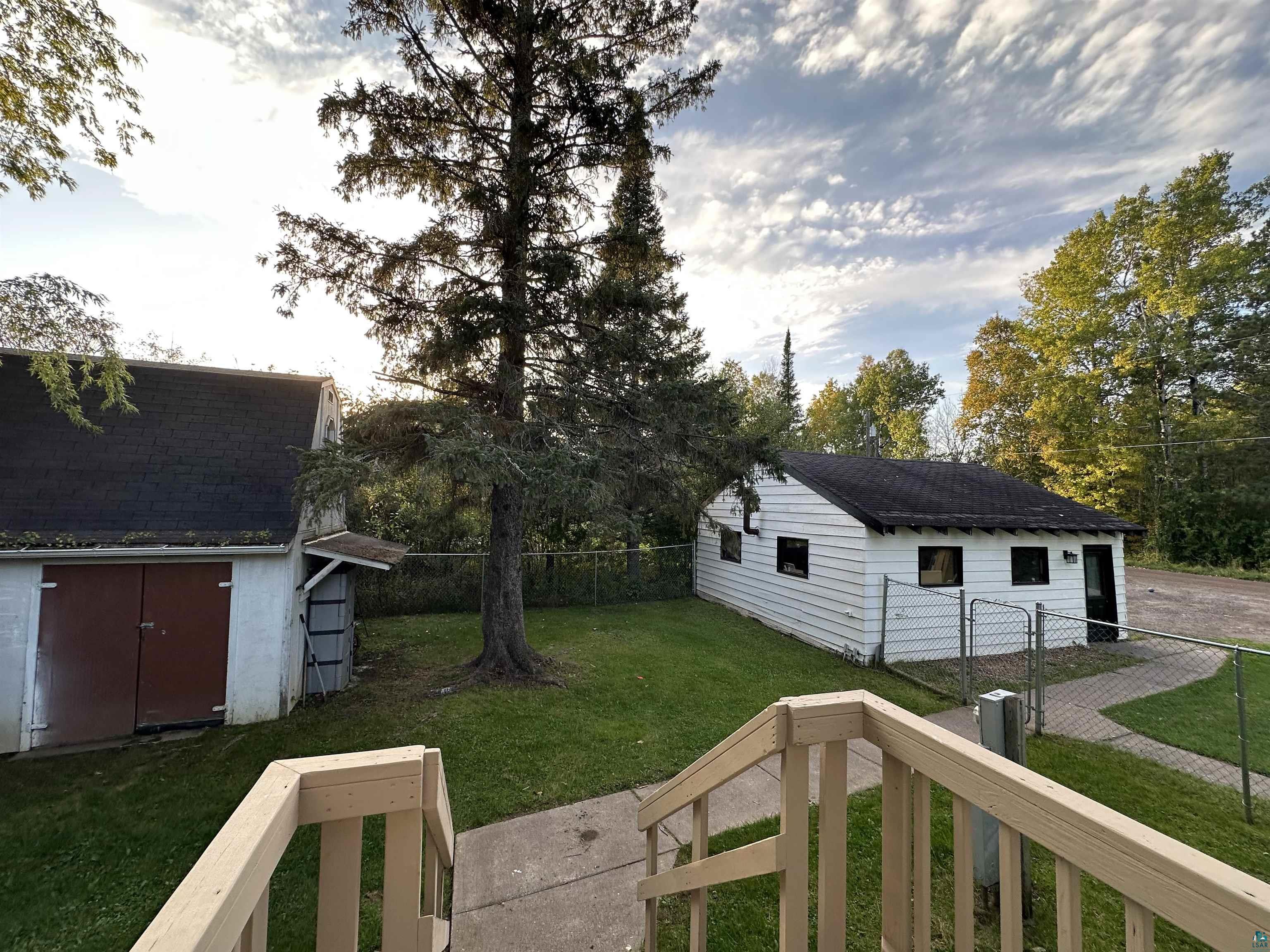 In between garage, shed, and house.