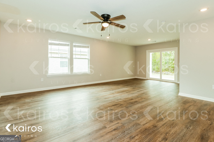 126 Cottage Grove Road Brunswick, GA 31525 - Photo 4 of 17 an empty room with wooden floor and windows