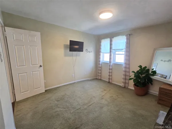 an empty room with potted plants