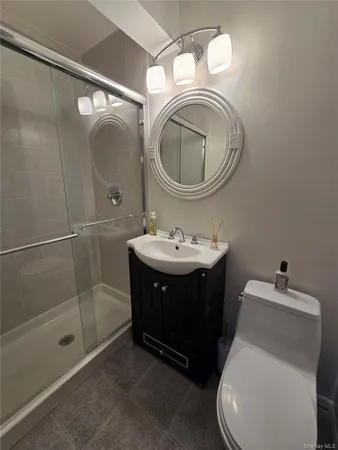 a bathroom with a sink vanity mirror and toilet