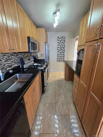 a kitchen with stainless steel appliances a sink stove and cabinets