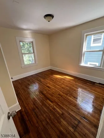 a view of an empty room and wooden floor