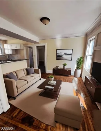 a living room with furniture a flat screen tv and a large window