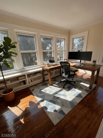 a living room with furniture window and wooden floor