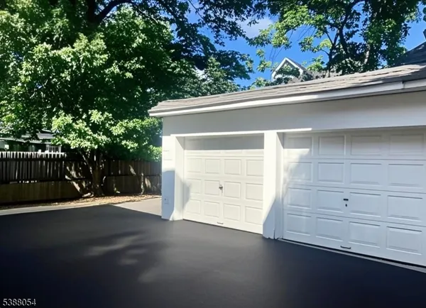 a view of empty room with wooden floor and window