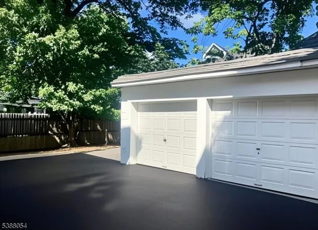 a view of empty room with wooden floor and window