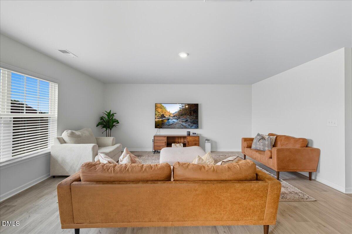 6854 Summerside Drive Whitsett, NC 27377 - Photo 12 of 49 a living room with furniture and a window