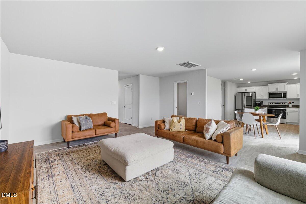 6854 Summerside Drive Whitsett, NC 27377 - Photo 13 of 49 a living room with furniture and a couch