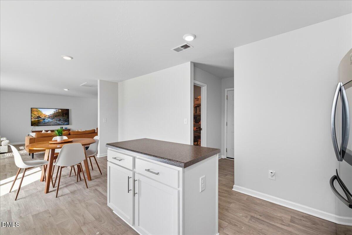 6854 Summerside Drive Whitsett, NC 27377 - Photo 20 of 49 a kitchen with stainless steel appliances granite countertop a stove and a refrigerator