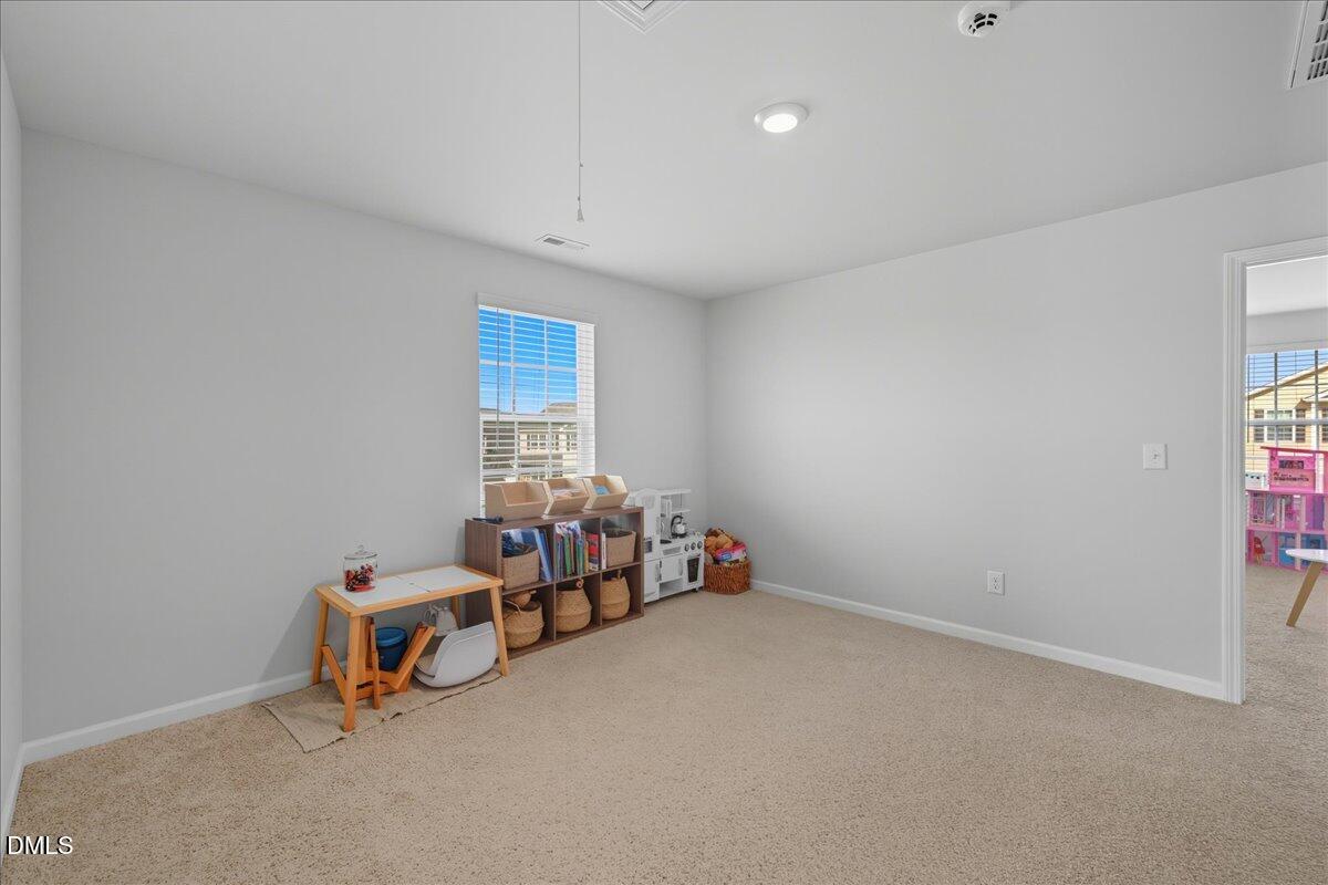 6854 Summerside Drive Whitsett, NC 27377 - Photo 25 of 49 a bedroom with furniture and a window