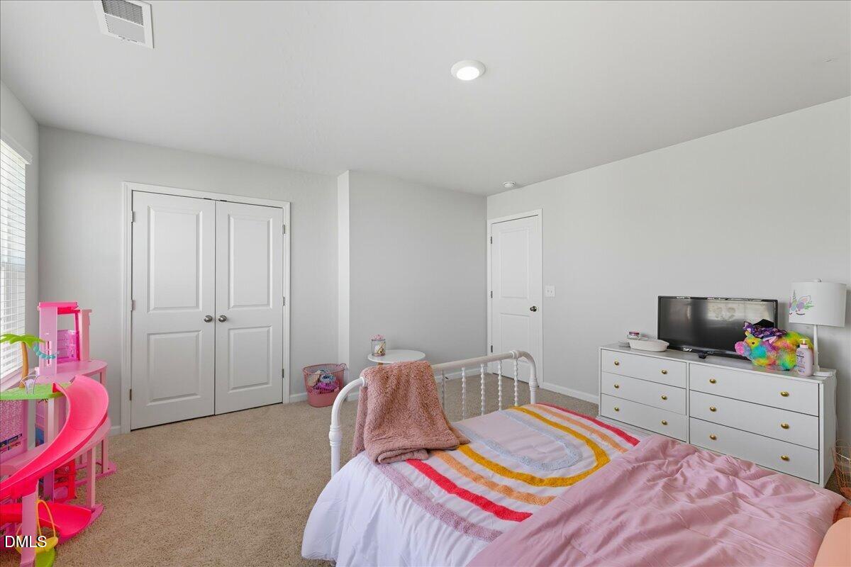 6854 Summerside Drive Whitsett, NC 27377 - Photo 28 of 49 a bedroom with a bed and a workspace