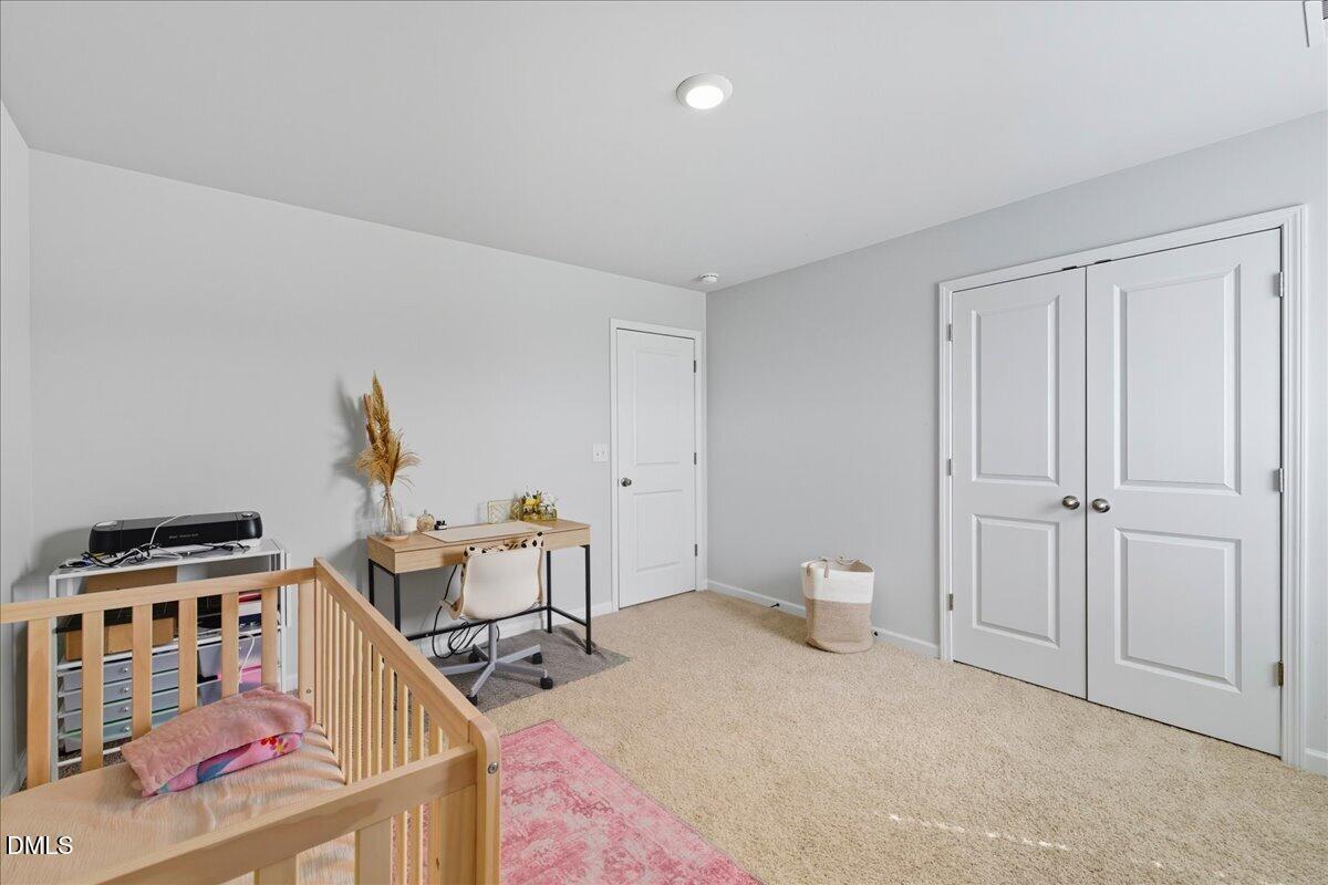 6854 Summerside Drive Whitsett, NC 27377 - Photo 30 of 49 a bedroom with furniture and a window