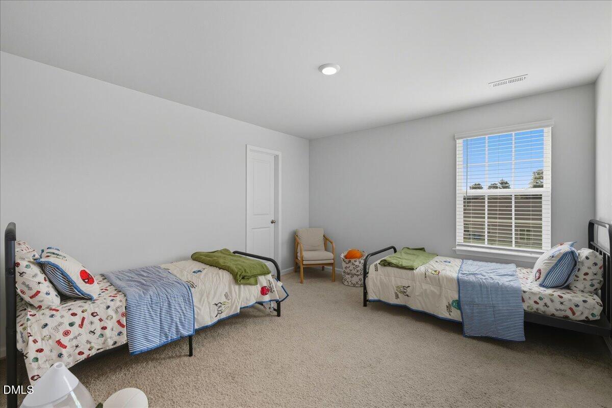 6854 Summerside Drive Whitsett, NC 27377 - Photo 31 of 49 a bedroom with two beds and a couch