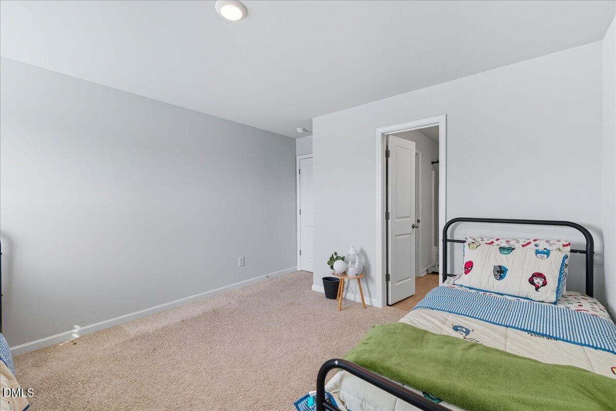 6854 Summerside Drive Whitsett, NC 27377 - Photo 32 of 49 a bedroom with a bed and a couch