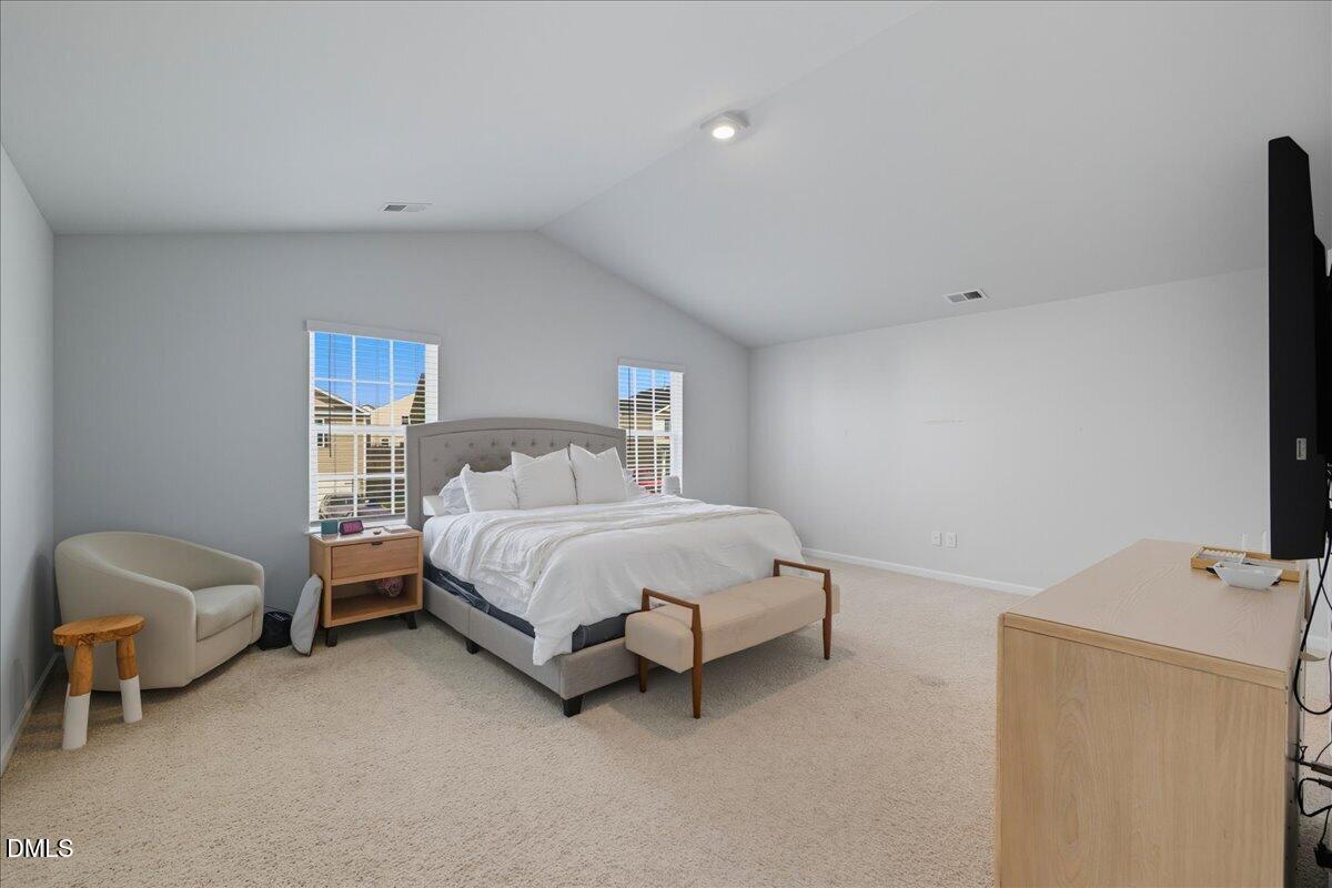 6854 Summerside Drive Whitsett, NC 27377 - Photo 35 of 49 a bedroom with a bed and a chair