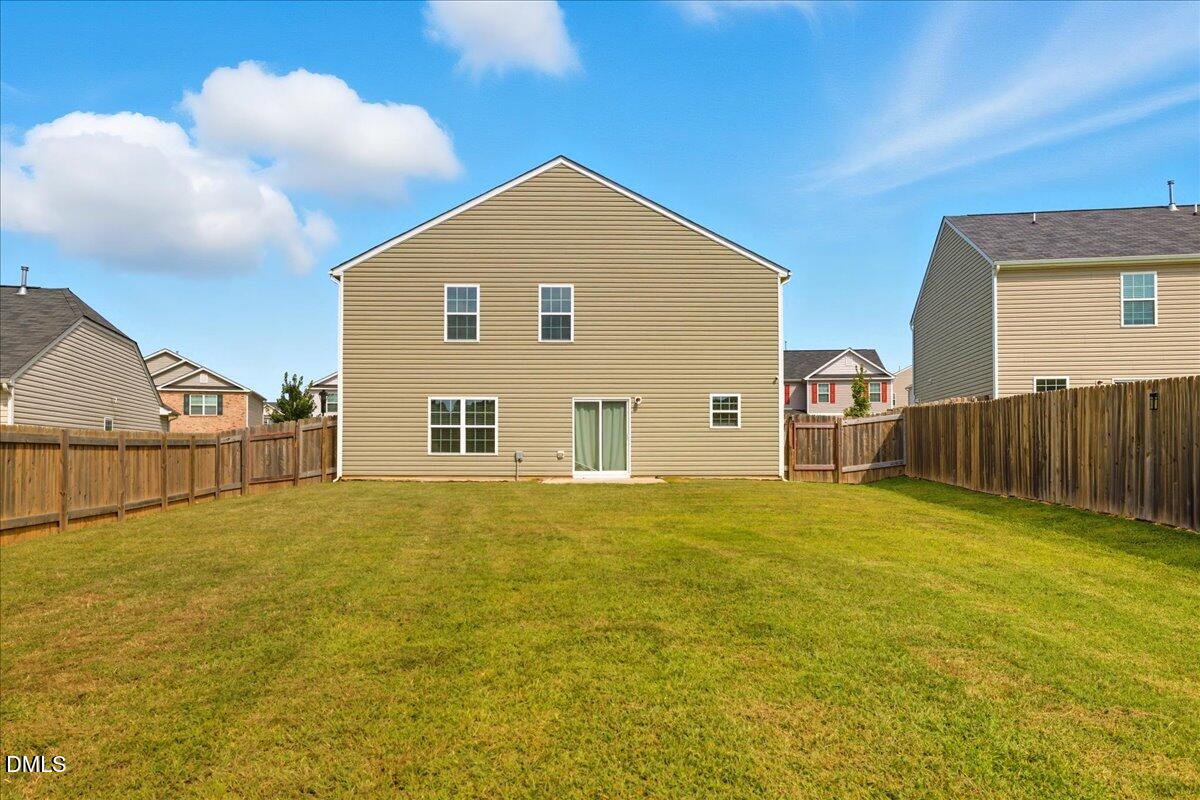 6854 Summerside Drive Whitsett, NC 27377 - Photo 41 of 49 a view of an house with backyard and road